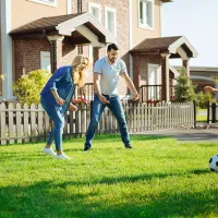 family playing soccer outside