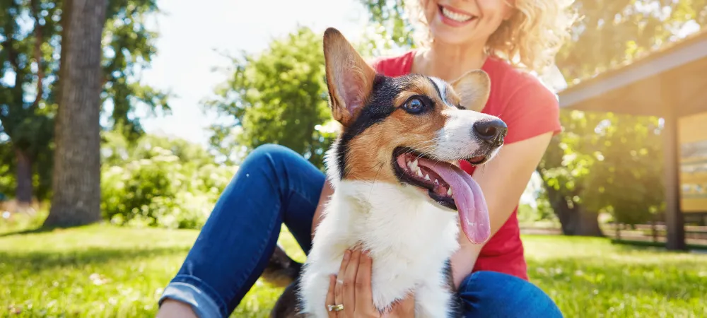 Woman enjoying her outdoor living area with her corgi.