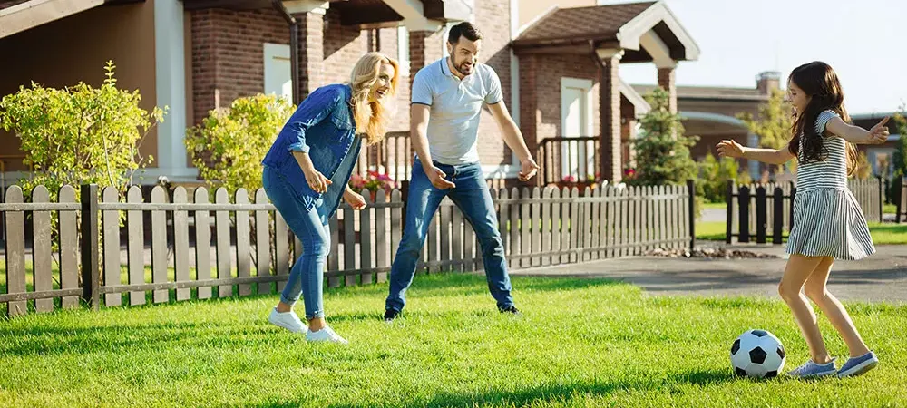 family playing soccer outside